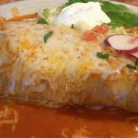 Burrito Ranchero · Tender shredded beef with beans wrapped in a warm flour tortilla smothered with ranchero sau...