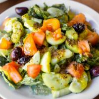 Green Salad - Large · Chopped spring greens, tomatoes, cucumbers, Kalamata olives, and topped off with our house d...