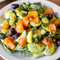 Green Salad - Small · Chopped spring greens, tomatoes, cucumbers, Kalamata olives, and topped off with our house d...