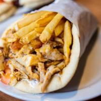 Chicken Gyro Pita · Thin slices of seasoned boneless chicken, stacked and cooked on a vertical rotisserie served...