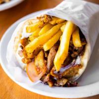 Pork Gyro Pita · Thin slices of seasoned pork, stacked and cooked on a vertical rotisserie served on a warm p...