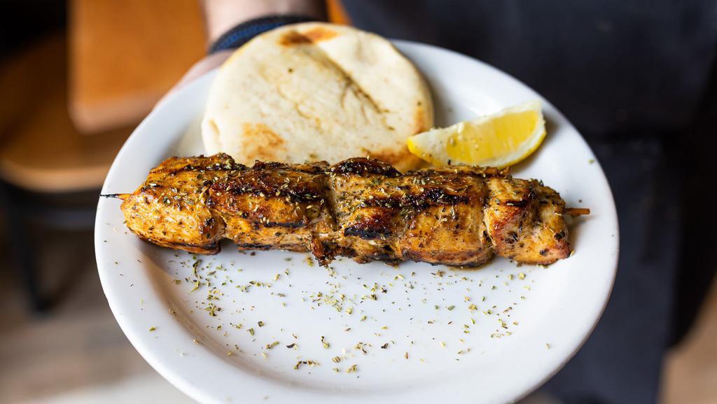 Chicken Souvlaki On A Stick · Seasoned chicken cubed and skewered on a stick, cooked over open flame and served with a mini pita.