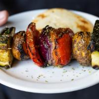 Vegetable Souvlaki On A Stick · Seasoned fresh vegetables skewered on a stick, cooked over open flame and served with a mini...