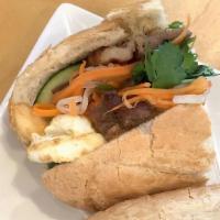 California Banh Mi · Baguette stuffed with grilled pork, French fries, fried egg, jalapenos and veggies.