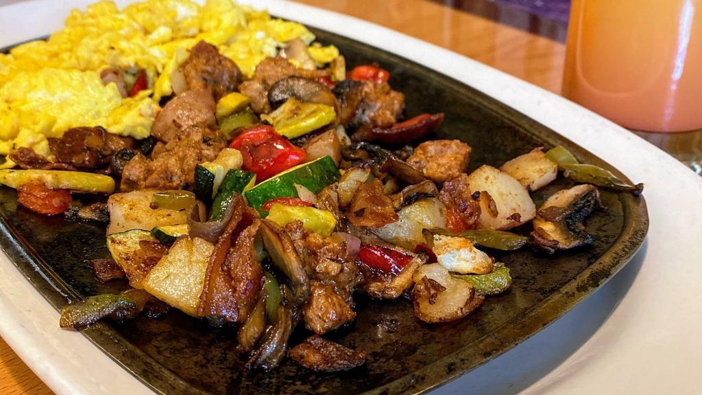 Breakfast Skillet · Fresh zucchini, onion, mushrooms, potatoes and bell peppers served on a sizzling platter with eggs and served with a side of tortillas, sour cream, guacamole and pico de gallo.