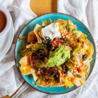 Los Pinos Nachos · Crispy tortilla chips topped with cheese, refried beans, tomato, green onion, olives, jalape...