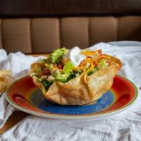 Taco Salad · Your choice of carnitas, chicken, ground beef or asada served in a crispy bowl with refried ...