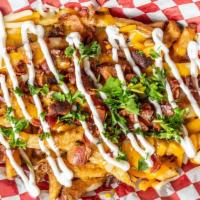 Loaded Handcut Fries · topped with creamy nacho cheese sauce, bacon and sour cream.