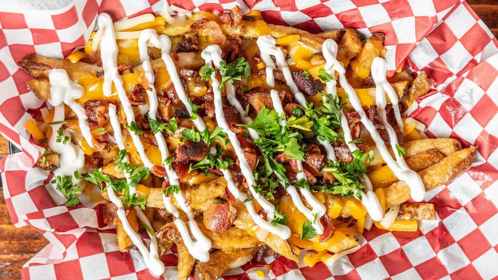 Loaded Handcut Fries · topped with creamy nacho cheese sauce, bacon and sour cream.