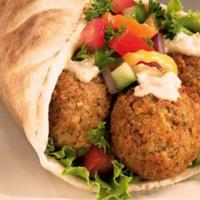 Veggie Falafel Wrap · Persian style Veggie falafel, fresh veggies, creamy tzatziki sauce, and peta cheese are nest...