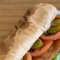 Catfish Po-Boy · Fried Catfish on a white roll with lettuce, tomato, pickles and po'boy sauce served with fri...