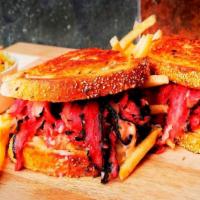 Reuben Sandwich · Served hot. Choice of pastrami, corned beef or turkey on grilled rye with Swiss cheese, Russ...