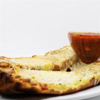 Garlic Cheese Bread · Fresh bread baked with garlic butter and herbs and topped with melted mozzarella and paprika.