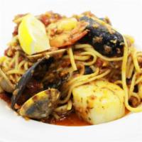 Seafood Linguini · Shrimp, scallops, calamari, black mussels  and clams in a light spicy tomato sauce.