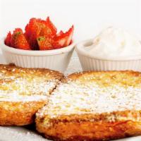 French Toast · White bread served with maple syrup, powered sugar and whipped cream. With cup fruit.