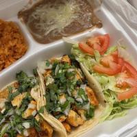 Tacos Plate · 2 pieces. Served with rice, beans, cheese, two meat tacos, onion, cilantro, and Chile.