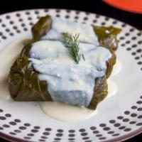 Dolmathes · Gluten free. Grape leaves stuffed with ground sirloin, rice, mint, dill, with avgolemono sau...