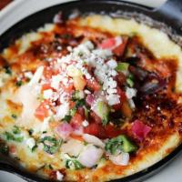 Queso Al Forno · Bubbling Mexican Cheeses, Green Onion, Serrano Chiles