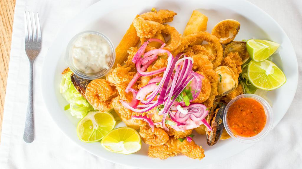 Jalea De Mariscos (Seafood) · Deep fried fish mixed with shrimps, calamari, mussels, clams and yucca or fries, served with tartar sauce, salsa criolla and Peruvian toasted com