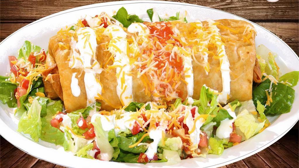Chimichanga · Fried flour tortilla, choice of meat, rice, beans, topped with sour cream, lettuce, cheese, tomatoes and salsa