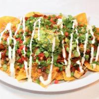 Chicken Nachos · Tortilla chips with your choice of Jimmy's grilled chicken or carnitas, refried beans, tomat...