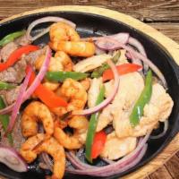 Fajitas Mixtas · Shrimps, steak and chicken served with rice, beans and tortillas.