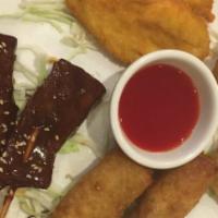 Flaming Pupu Platter (2 Pieces Each) · Egg rolls, chicken meat ball, fried wonton, chicken satay, and beef satay.