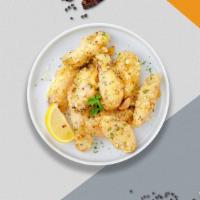 Cheesy Garlic Vegan Wings · Fresh vegan chicken wings breaded, fried until golden brown, and tossed in garlic and parmes...