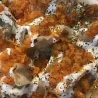 Mantoo Veggie · Steamed dumpling with mushrooms, cabbage, onion, spices, topped with garlic yogurt, split pe...