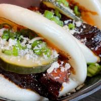 Pork Belly Sliders · Three pork belly bao sliders, cucumbers, chives, sticky Chinese five spice sauce, spicy srir...