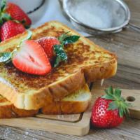 Strawberry French Toast · French toast battered with eggs, milk, cinnamon, and sugar topped with fresh strawberries