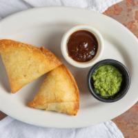 Vegetable Samosa (2) · Vegetarian. Triangular pastry stuffed with potatoes and peas and nuts.