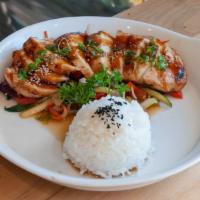 Chicken Teriyaki · Grilled chicken served on a bed of stir-fried vegetables with rice; topped with sesame seeds...