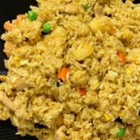 Pineapple Fried Rice · Fried rice with curry powder, pineapples, cashew nuts, green peas, carrots, and raisins.