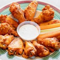 Buffalo Wings · Meaty and mildly spiced buffalo style chicken wings served with carrots and celery and a sid...