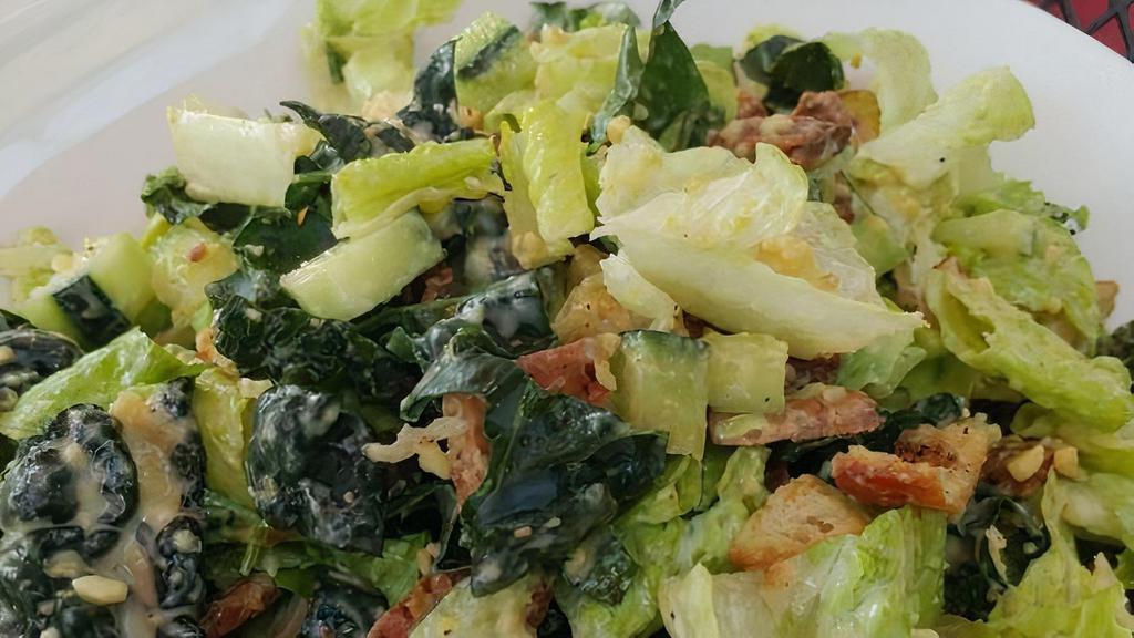 Vegan Kale Caesar · Tuscan kale, crisp romaine tossed with avocado, cucumber, house-made cashew 'parmesan