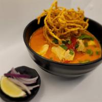 Khao Soi · Classic Thai curry noodle soup. Prepared with egg noodle, chicken slice topped with crispy e...