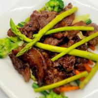 Moo Ping · BBQ pork tender with steamed vegetables.