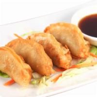 Gyoza · Potstickers stuffed with pork and shredded cabbage served with soy sauce.