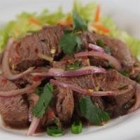 #19. Thai Spicy Beef Salad · Grilled strips of beef flavored with lime juice, chili flakes and onions over mixed greens.
