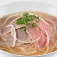 Rare Steak & Well Done Beef Pho Soup · Rare slices of steak and well-done flank with onions, green onions, cilantro, and rice stick...