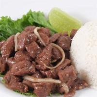 Beef Steak · Diced beef steak pan-fried with garlic, soy sauce, and onions, with steamed rice.