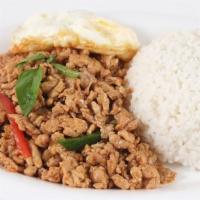 Mint Leaf Chicken · Ground chicken stir fried with garlic and basil leaves served with fried eggs and steamed ri...