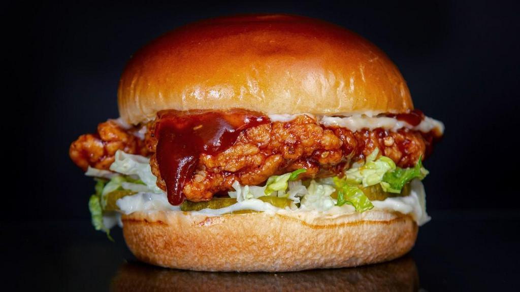 The Bbq Sandwich · Southern fried and hand breaded chicken breast seasoned in our signature Sam's New Orleans style spice, tossed in BBQ sauce, in between a toasted brioche bun with pickles, shredded romaine, and mayo.