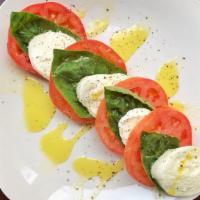 Caprese Salad · Fresh sliced mozzarella, tomatoes and fresh basil.