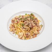 Spaghetti Carbonara · spaghetti pasta, roasted garlic cream sauce, parmesan cheese, onions, bacon, egg yolks.