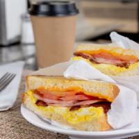 Grilled Breakfast Sandwich · 2 Scrambled Eggs, Tomatoes, Bacon, Ham & Cheese.