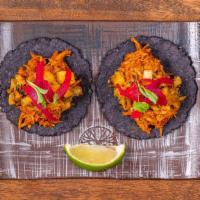 Chicken Tinga  · Slow-cooked chicken tinga, grilled pineapple habanero salsa, pickled onion.