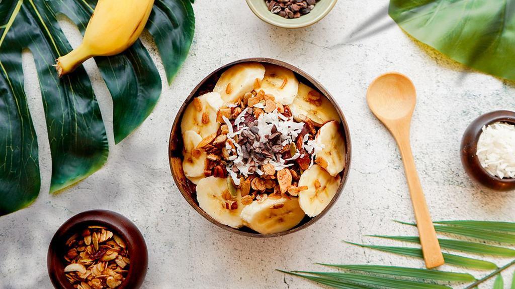 Coco Cacao Bowl · Acai bowl topped with granola, cacao nibs, honey, bananas, and shredded coconut.