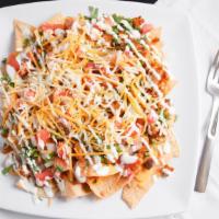 Super Nachos · Nacho chips, your choice meat, nacho cheese, refried pinto beans, sour cream, shredded Mexic...